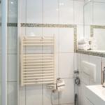 Bathroom with shower, towel rack, and sink