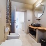 Bathroom with toilet, bidet, sink, and shower