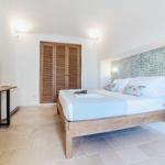 Bedroom with wooden bed, TV and wooden closets.