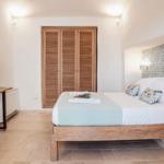 Bedroom with bed, wardrobe, and TV stand.