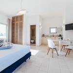 Schlafzimmer mit Bett, Schlafzimmer und Essbereich mit Tisch und Stühlen.