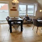 Wohn- und Essbereich mit Sofa, Tisch und Küchenbereich.