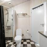 Bathroom with shower, toilet, and sink.