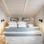 Bedroom with mattress, pillows, and drawers