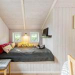 Bedroom with bed, windows, wall art, and TV.