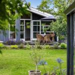 House with terrace, garden, and outdoor seating.