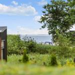 House with view of water and green garden