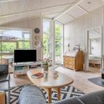 Living room with fireplace, sofa, TV, and view of terrace