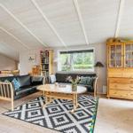 Living and dining area with wooden furniture and large window.