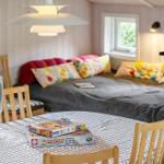 Bedroom with bed, window, and dining table with chairs.