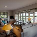 Living room with sofa, coffee table, and windows to the garden