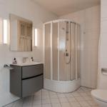 Bathroom with shower, sink, and toilet.