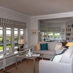 Living room with sofa, coffee table, and garden view