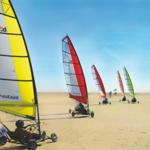 Sailbikes auf Sandstrand unter blauem Himmel