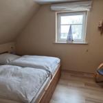 Bedroom with double bed, window and chair