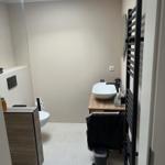 Bathroom with shower, sink, and heater