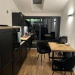Kitchen with dining area and bedroom in the background.