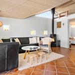 Living room with sofa, fireplace, and terracotta floor