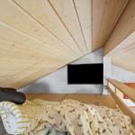Bedroom with wooden ceiling, bed, and TV