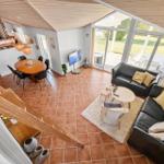 Living and dining area with kitchen, sofa, and terrace.