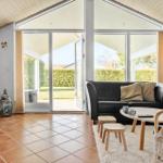 Living room with sofa, TV, and view of garden