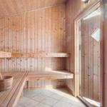 Sauna mit Holzwand, Sitzbänken und Eimer