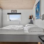 Bedroom with bed, window, and wall shelves.