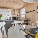 Kitchen with dining area, game board, and flowers on table