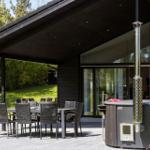 Terrace with table, chairs, and hot tub under roof