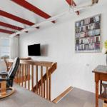 Room with seating, TV, and harbor view