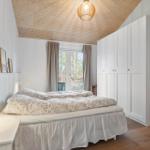 Bedroom with bed, closet, and window to the outside.