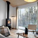 Living room with fireplace, large window, and seating area