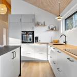 Modern kitchen with wooden surfaces and white cabinets