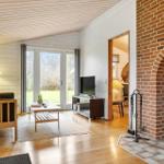 Wohnzimmer mit Kamin, Sofa, TV und Terrassentür.