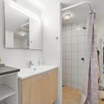Bathroom with shower, sink, and towel rack