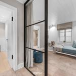 Schlafzimmer mit Blick auf Bad und Sitzecke mit Fenster