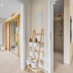 Badezimmer mit Dusche und Toilette, daneben Sauna und Fensterblick.