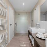 Badezimmer mit Dusche, Waschbecken und Handtuchhalter