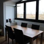 Dining area with table, chairs, and window view