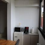 Kitchen area with microwave, coffee maker, and refrigerator.