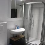 Bathroom with shower, sink, and mirror