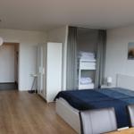 Bedroom with double bed, bunk bed, and wall art