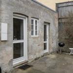 House with entrance door, window and grill area in courtyard