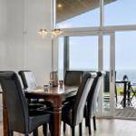 Dining room with sea view. Table with chairs and terrace.