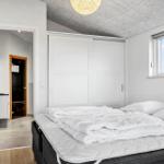 Bedroom with bed, wardrobe, and window. Corridor to sauna and kitchen.