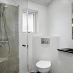 Bathroom with shower, toilet, and sink.