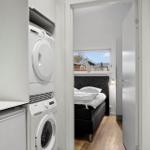 Apartment with washing machine, dryer, and bedroom with window.