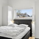 Bedroom with bed, window, and wardrobe.