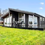 Modern villa with large outdoor terrace and seating area.