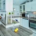Kitchen with white cabinets, worktop, and sink.